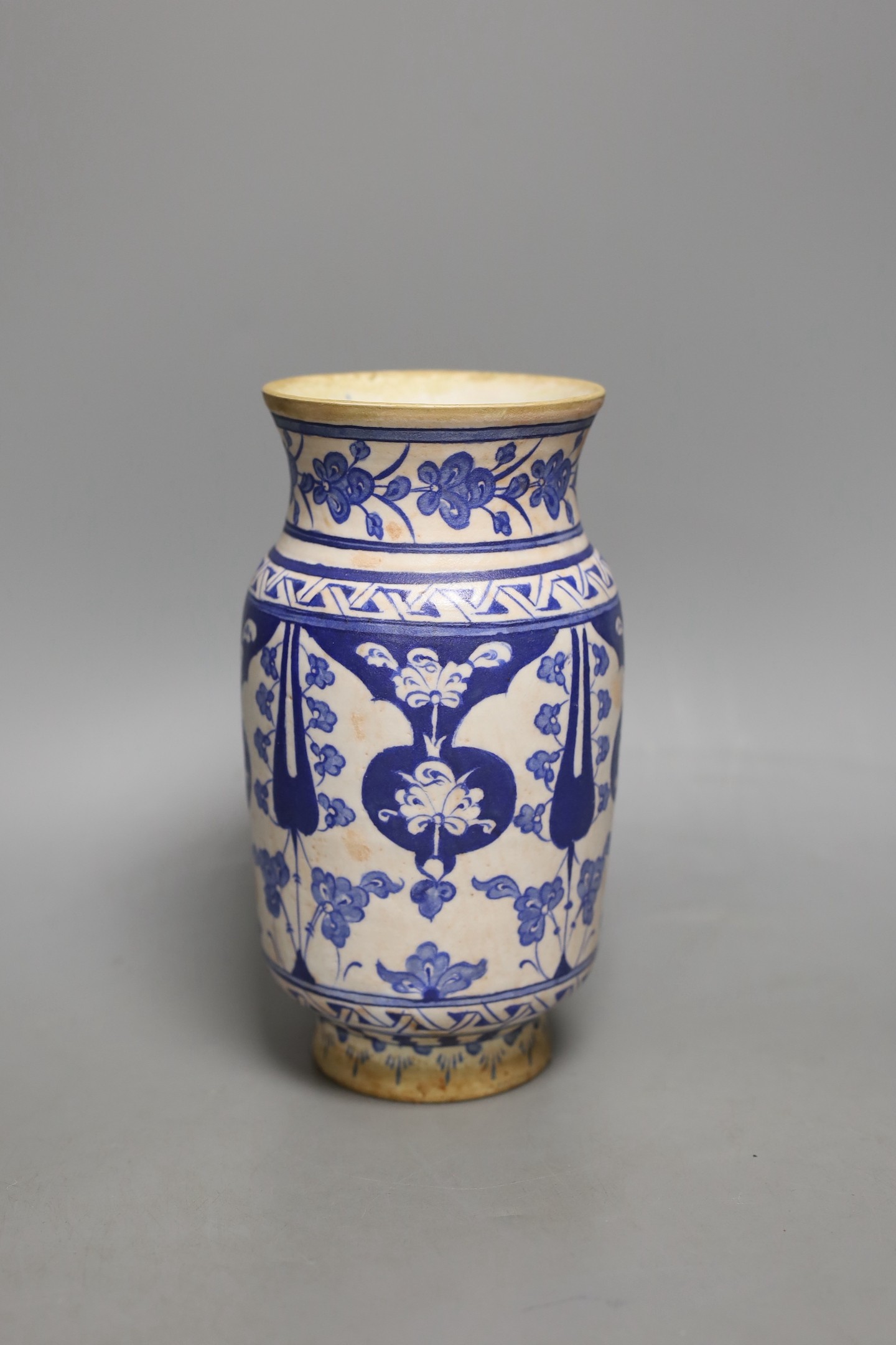 An Iznik fritware vase, 20.5 cms high.